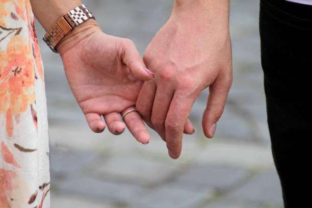 istock Close-up of couple holding hands 1016496924