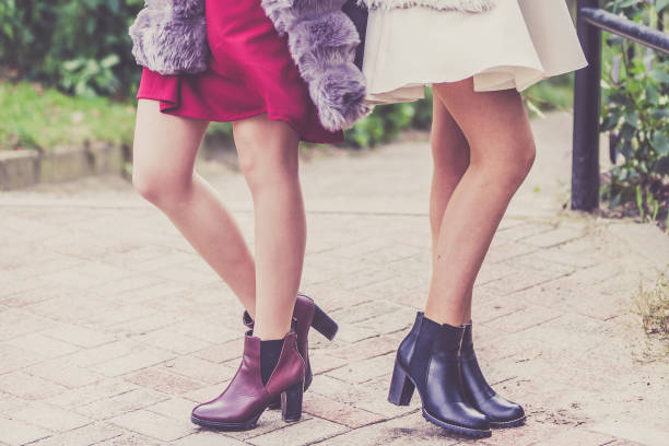 istock Two women presenting shoes outdoor 1016498044