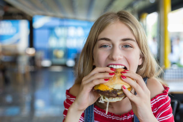 istock Woman eating burger 1016498522