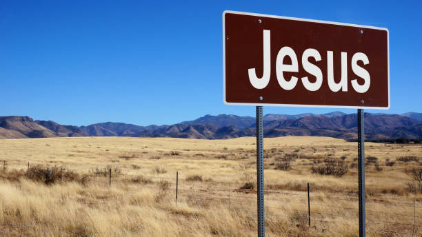 istock Jesus brown road sign with blue sky 1016498610