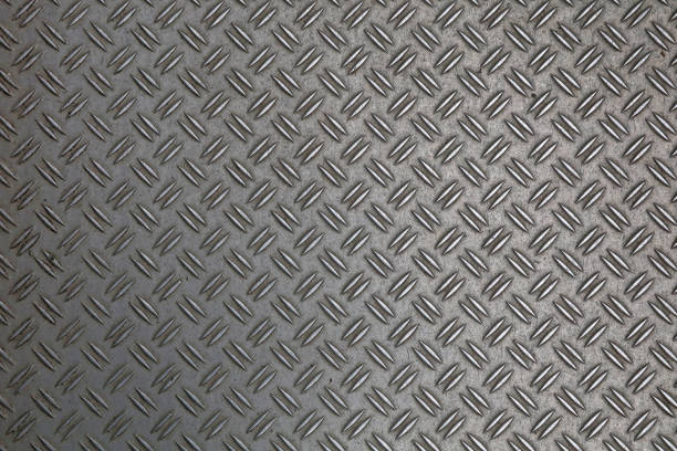 Anti slip gray metal plate with diamond pattern Dark gray industrial anti slip embossed metal steel plate with double diagonal bumps of diamond pattern texture, background, close up metal stud stock pictures, royalty-free photos & images