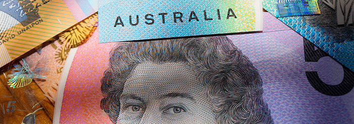 London, UK: July 25, 2018: Australian five, ten and fifty dollar bills in a panoramic format with image distortion. The new issue is designed to deter counterfeiting, the note is polymer and water resistant.