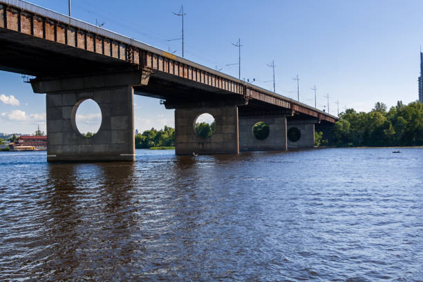 istock Bridge on a river against a blue sky and clouds 1016505268