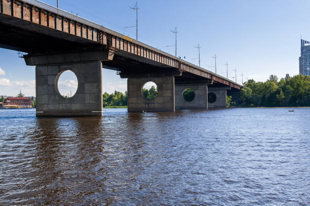 istock Bridge on a river against a blue sky and clouds 1016505424