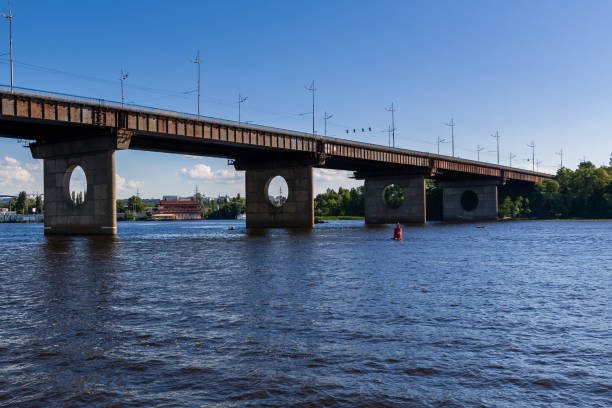 istock Bridge on a river against a blue sky and clouds 1016509688