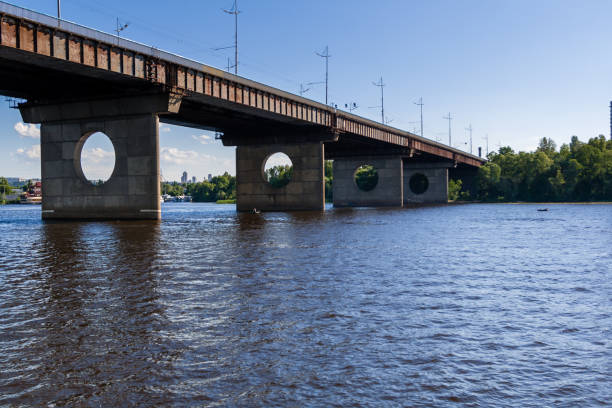 istock Bridge on a river against a blue sky and clouds 1016509838