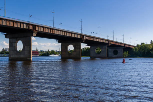 istock Bridge on a river against a blue sky and clouds 1016509892