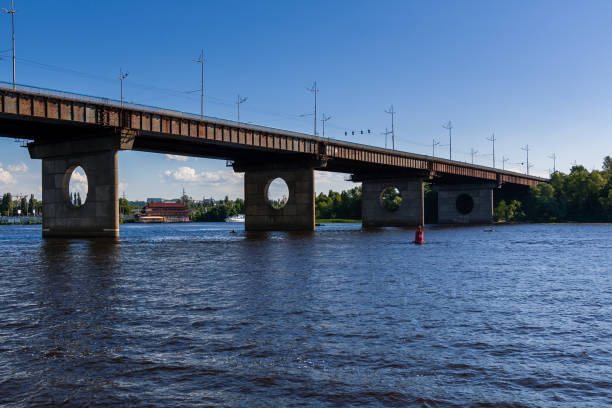 istock Bridge on a river against a blue sky and clouds 1016509898