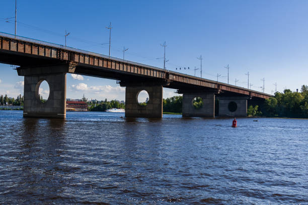 istock Bridge on a river against a blue sky and clouds 1016510306