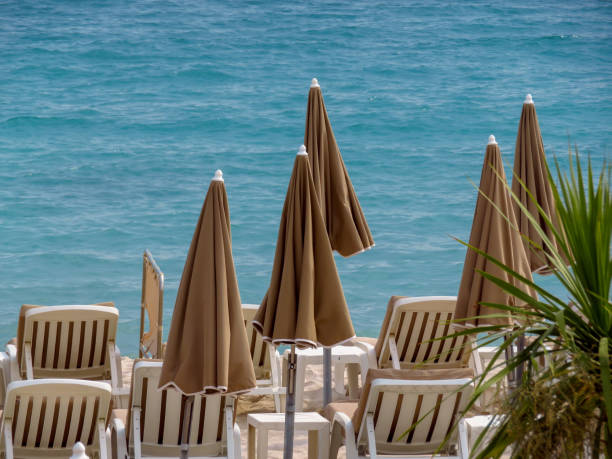 istock Cannes - Beige umbrellas on a beach 1016513126