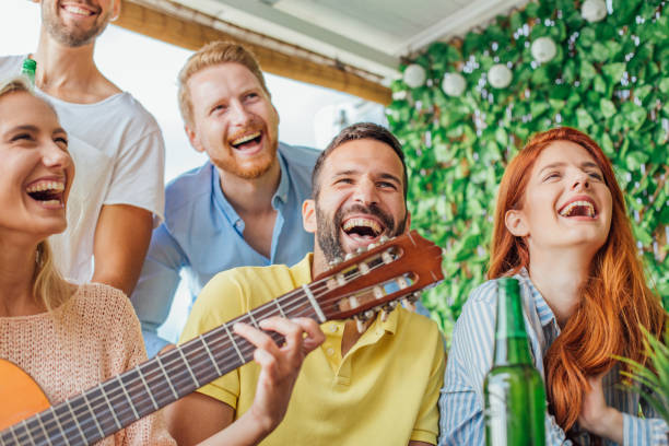 istock Laughing young people with acoustic guitar 1016513260