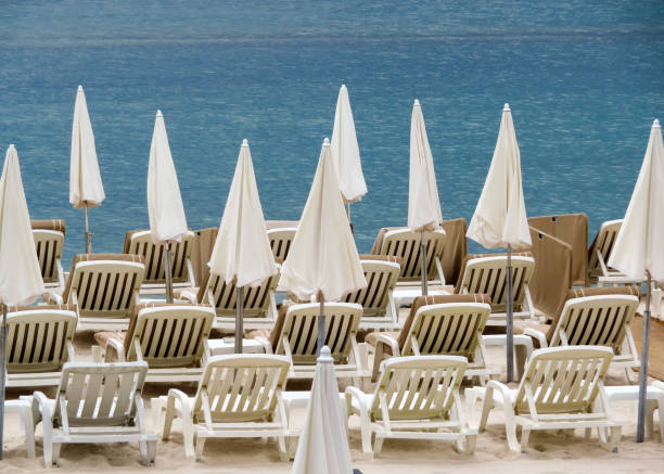 istock Cannes - White umbrellas on a beach 1016513288