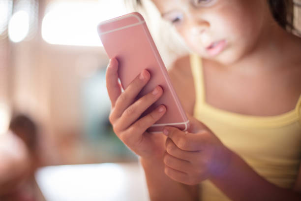 istock Little girl watching something on phone. 1016513658