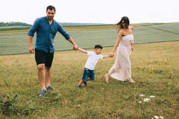 istock parents and son holding hands on field 1016513816