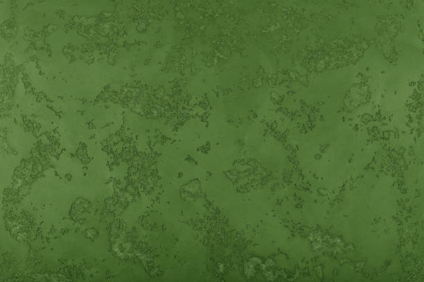 istock Grunge green painted plaster wall background 1016513864