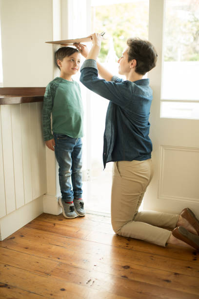 istock Mom takes his measurement every year 1016522630