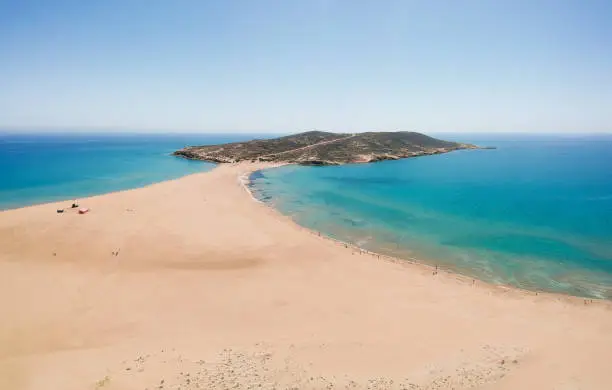 Photo of Aerial birds eye view drone photo Prasonisi on Rhodes island, Dodecanese, Greece. Panorama with nice lagoon, sand beach and clear blue water. Famous tourist destination in South Europe