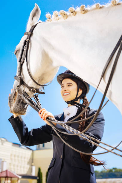 istock Appealing female rider laughing white spending time on race track 1016537518