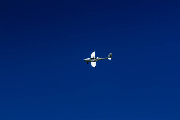 istock The plane flies in the blue sky 1016540178