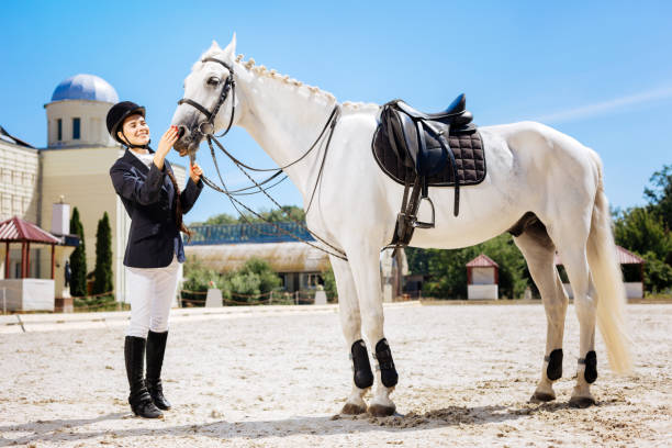 istock Beaming female rider getting ready for important contest 1016540578