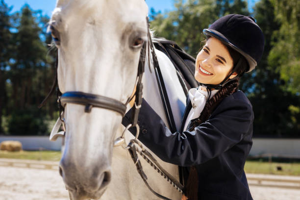 istock Dark-eyed horsewoman with long braid feeling contended 1016541068