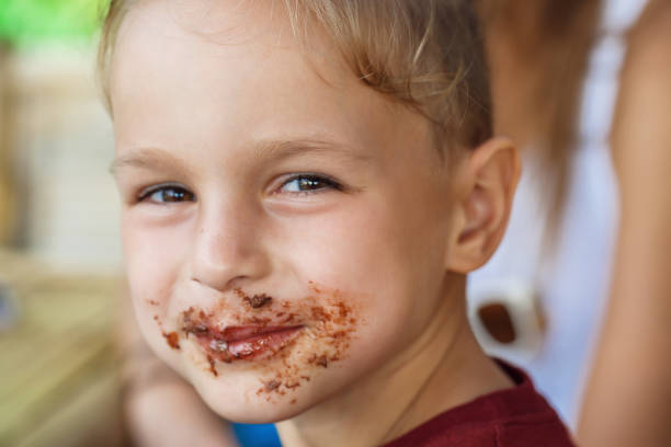 istock boy eating pancake with banana and chocolate 1016541508