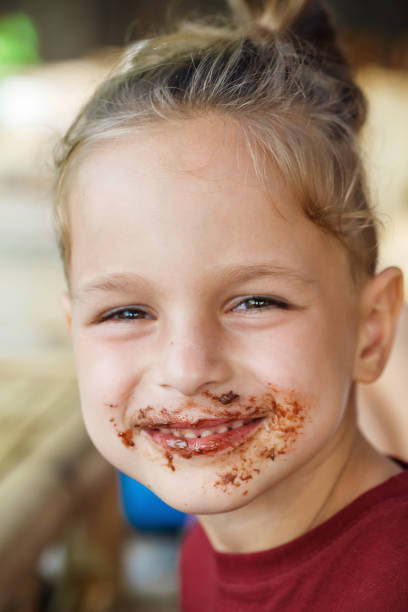 istock boy eating pancake with banana and chocolate 1016541782