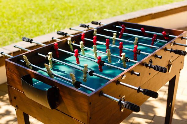 istock Cropped image playing foosball while resting outdoors 1016546630