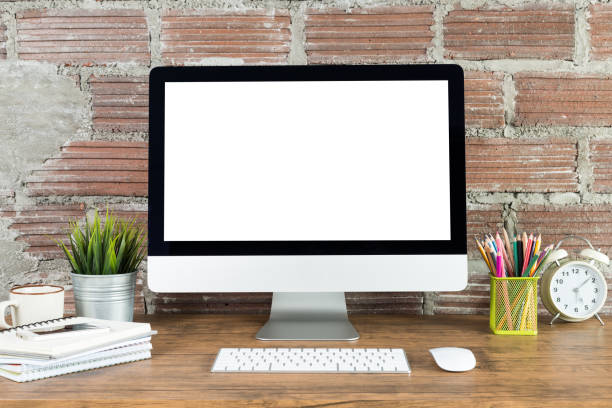 istock workspace with computer with blank white screen, and office supplies on a wooden desk 1016547468