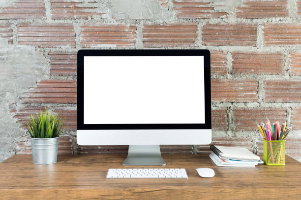 istock workspace with computer with blank white screen, and office supplies on a wooden desk 1016547502