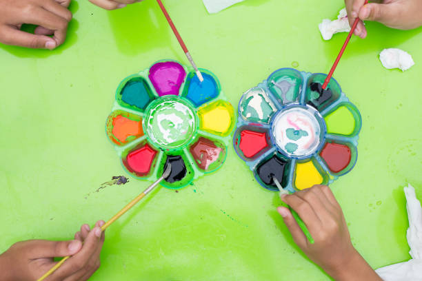 istock Top view Color palette with children's hand 1016547592