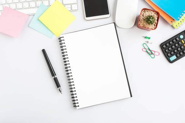 istock Top view, empty notebook and office supplies on the desk. 1016547650