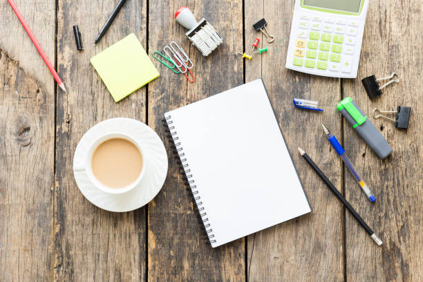 istock Office table with blank paper on old wooden table 1016547852