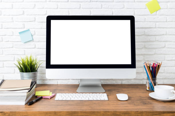 istock workspace with computer with blank white screen, and office supplies on a wooden desk 1016547902