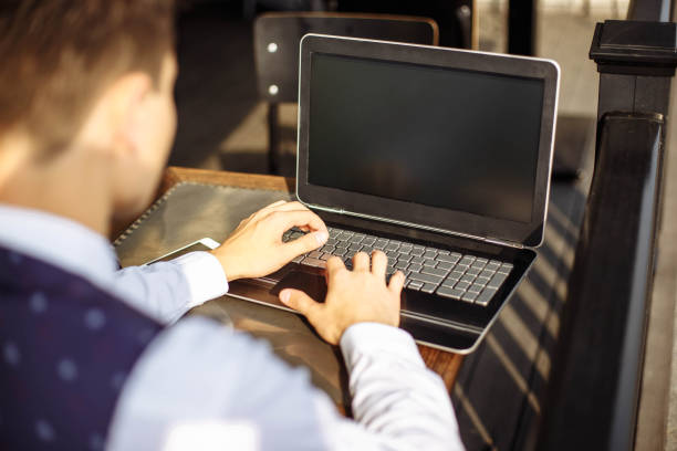 istock Successful manager working in cafe during break and searching information in internet on his notebook computer 1016552310