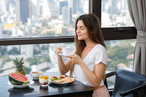 istock Young woman eating breakfast at morning 1016556104