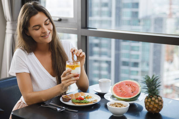 istock Young woman eating breakfast at morning 1016556142