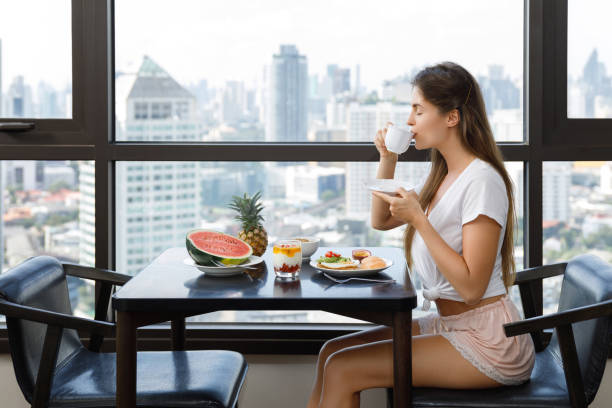 istock Young woman eating breakfast at morning 1016556178