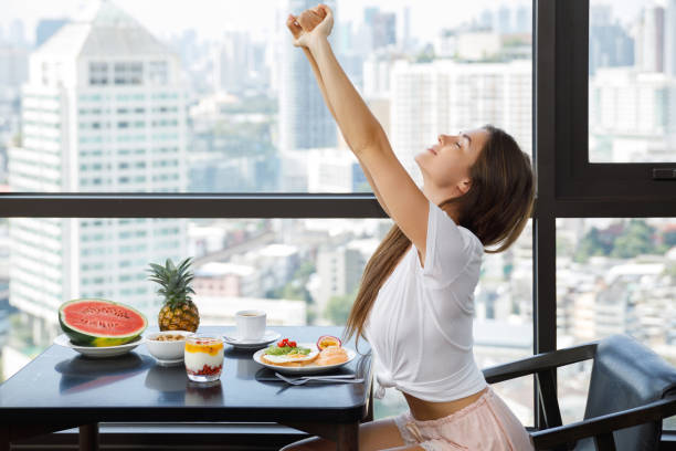 istock Young woman eating breakfast at morning 1016556230