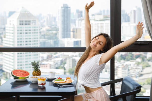 istock Young woman eating breakfast at morning 1016556264