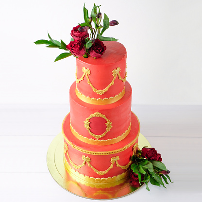 Threetiered Red Wedding Cream Cake Decorated With Flowers And Gold Elements On A White Wooden Table Stock Photo - Download Image Now - iStock Threetiered Red Wedding Cream Cake Decorated With Flowers And Gold Elements On A White Wooden Table Stock Photo - Download Image Now - Istock