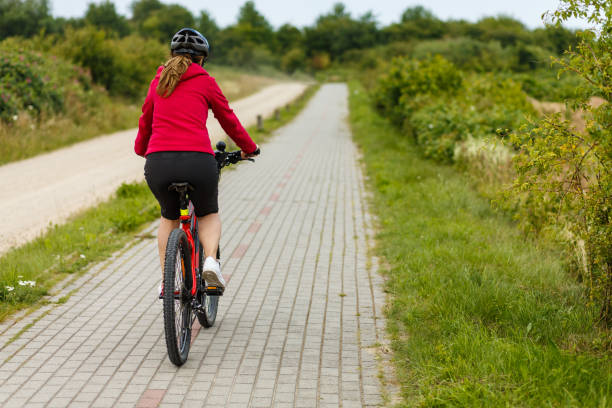 istock Woman riding bike 1016559732