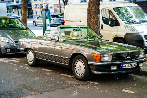 Paris: Vintage Mercedes-Benz SL convertible car parked on Paris street with opened roof-top