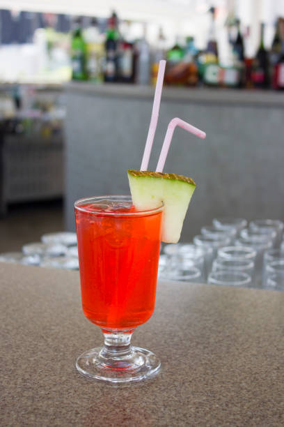 istock Red cocktail with a slice of melon at the bar 1016567724