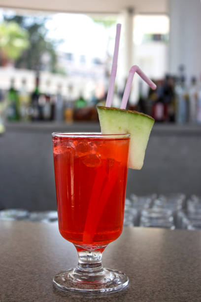 istock Red cocktail with a slice of melon at the bar 1016567806