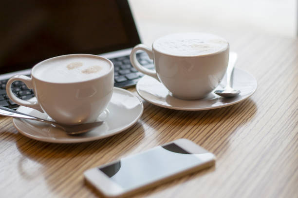 istock two cups of coffee on the desktop with the tablet 1016571356