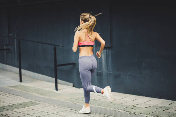 istock Blonde women running. From back.  Moving activity. 1016574494