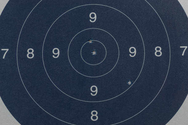 istock Bullet holes in the black target 1016578094