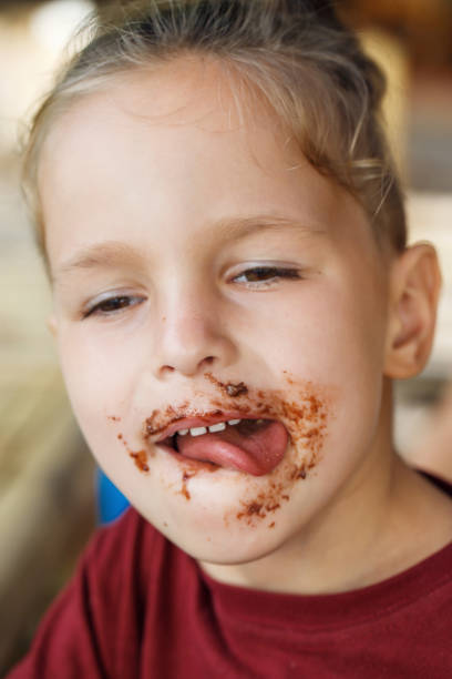 istock boy eating pancake with banana and chocolate 1016585894