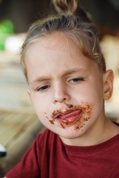 istock boy eating pancake with banana and chocolate 1016585910